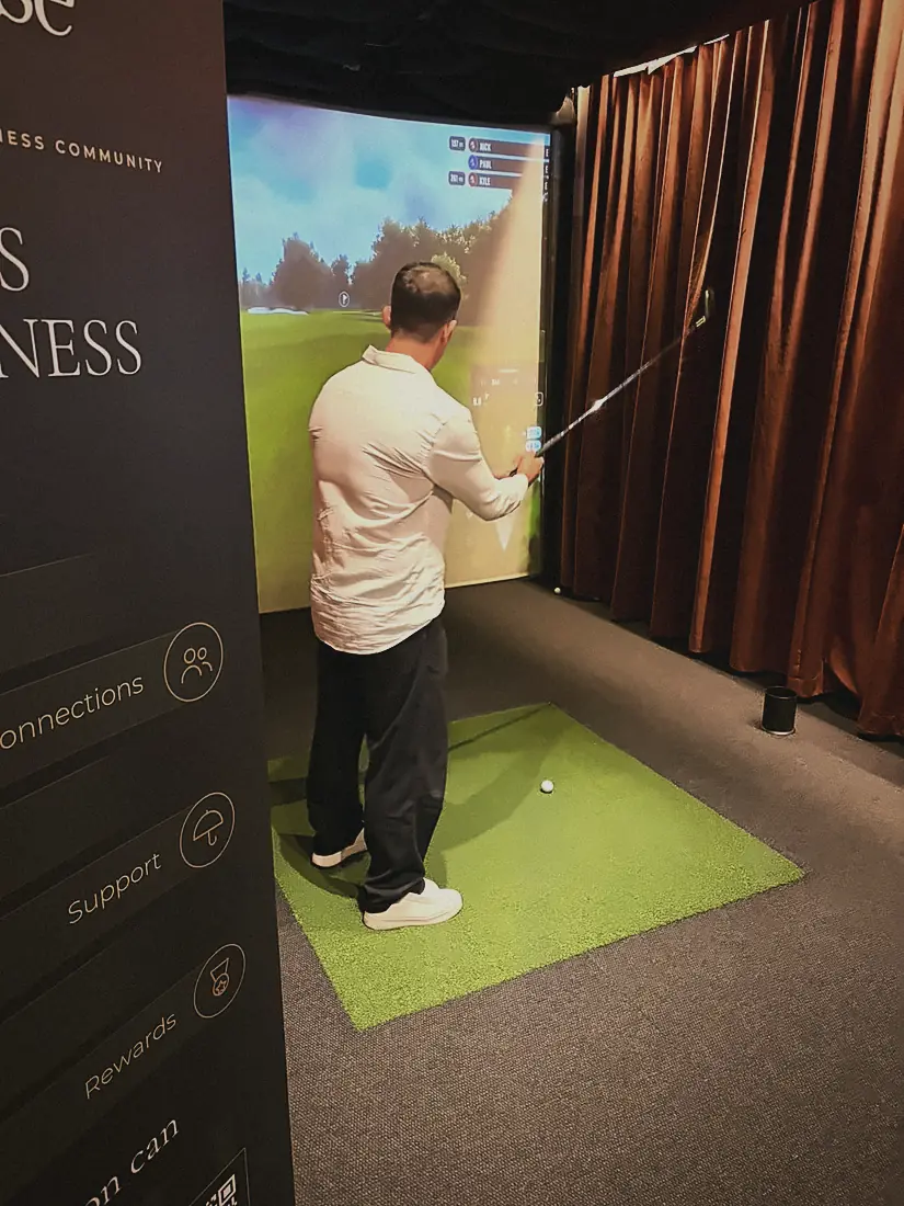 A member taking a swing on a golf simulator at Pitch