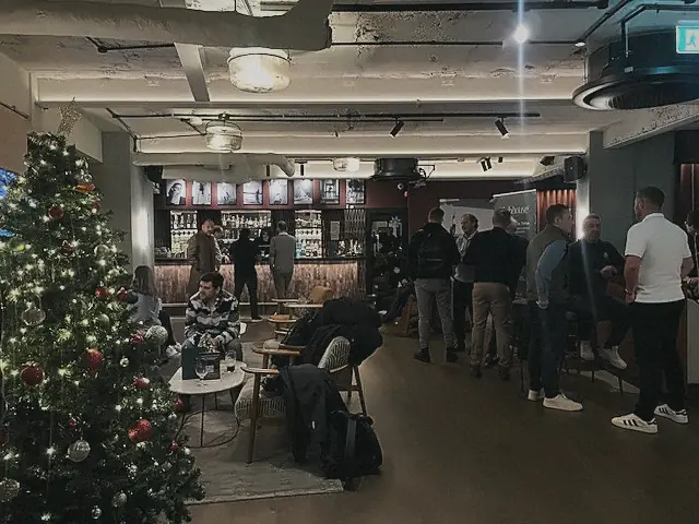 Members and guests by the Christmas tree at Pitch